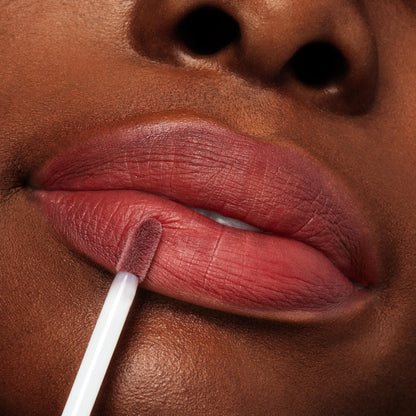 Doe-foot applicator glides a rosy-mauve stain onto lips, showcasing the creamy, blendable finish of Blush n' Pout, a ColourPop Cheek & Lip Set, in a tight beauty close-up for effortless lip-and-cheek color.